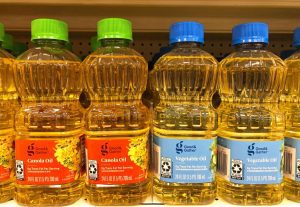 Grocery store shelf with with bottles of Good and Gather brand Canola Oil and Vegetable Oil